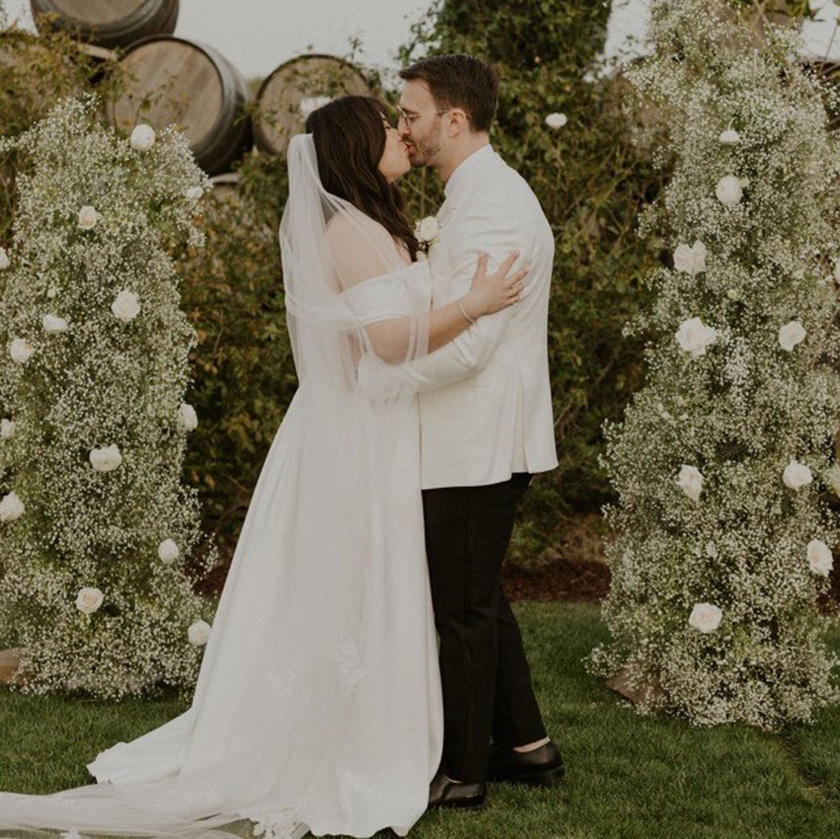 Newly wed couple kissing in the vineyard